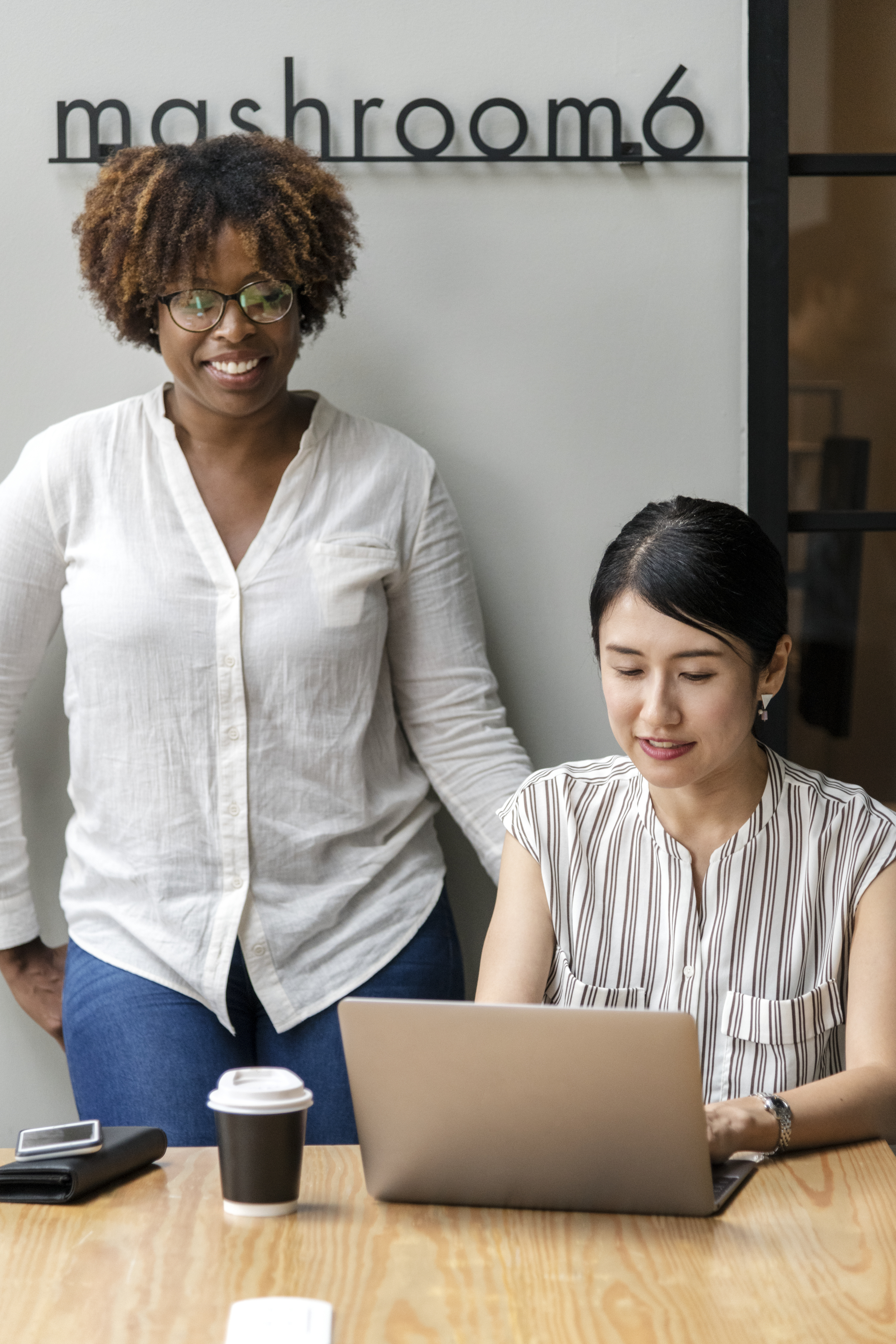 two women viewing a laptop screen